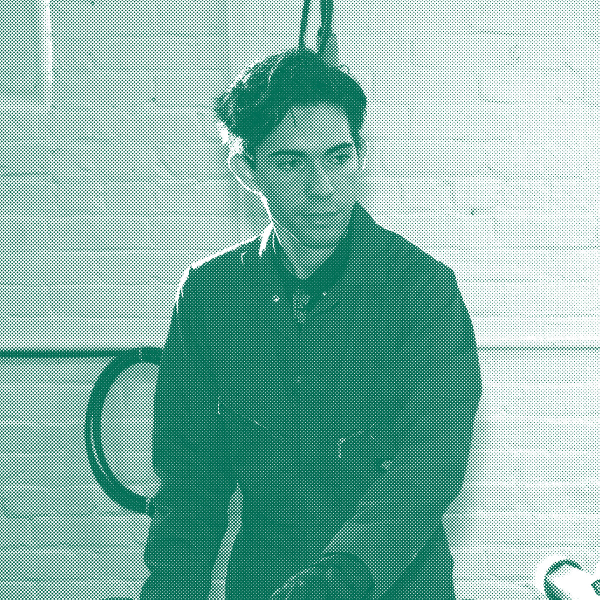 Kyle Legerski, Art Director at Frontside Factory, operates the 6 color hand screen print press.